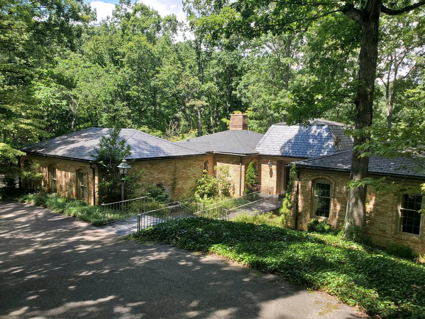 a front view of a house with garden