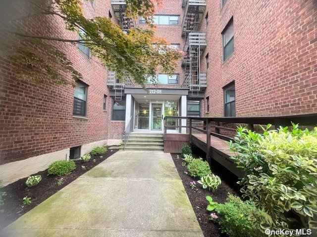 a view of a house with potted plants