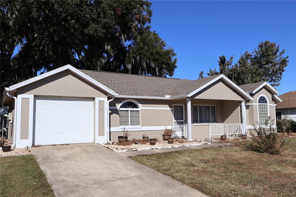 a view of a house with a yard and garage