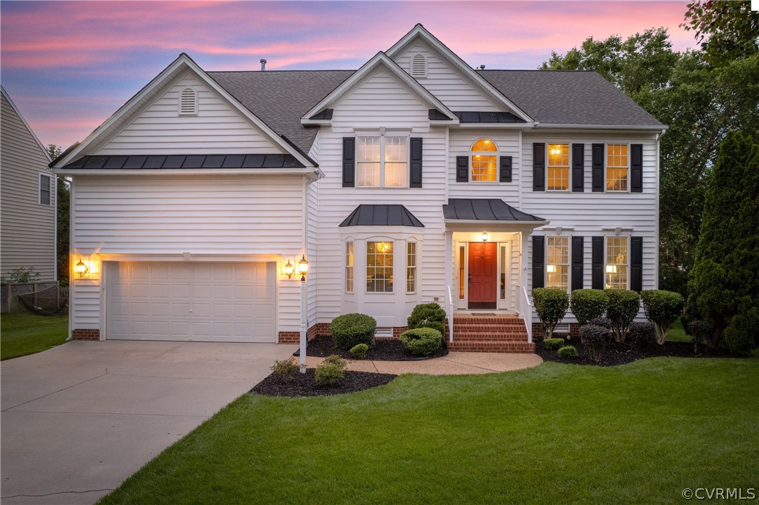 a front view of a house with a yard and garage