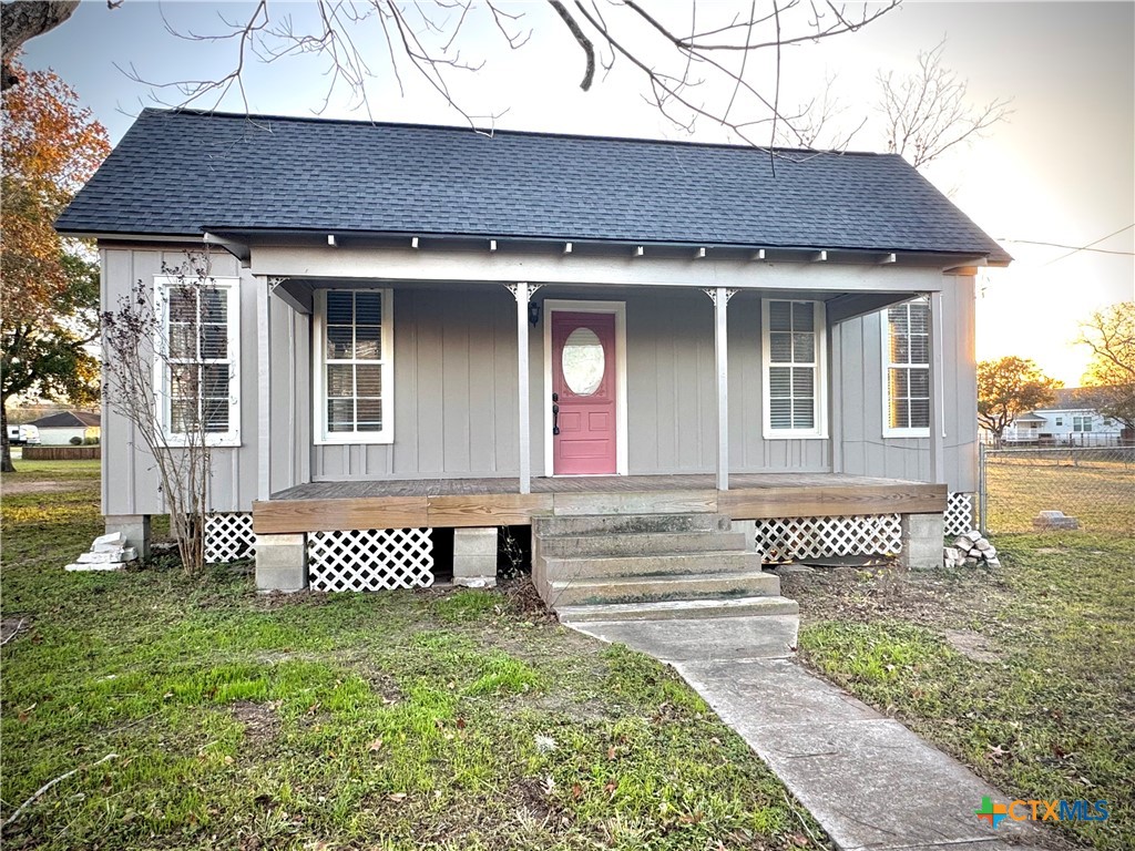 a front view of a house with a garden