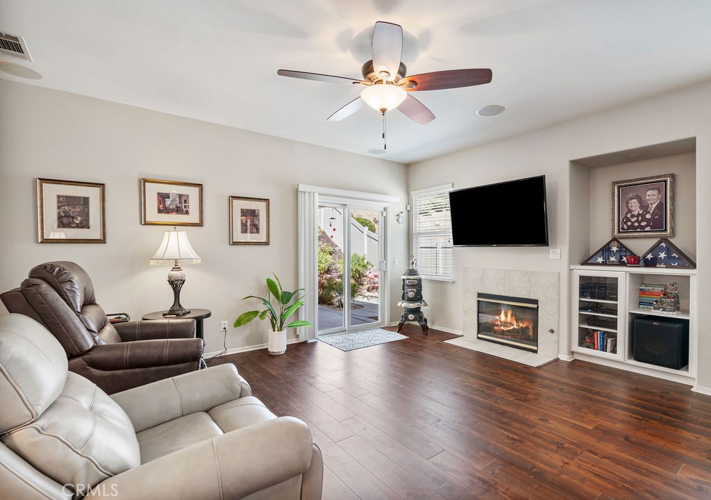 Living room features a fireplace and wall-mounted big screen TV *INCLUDED IN SALE*
