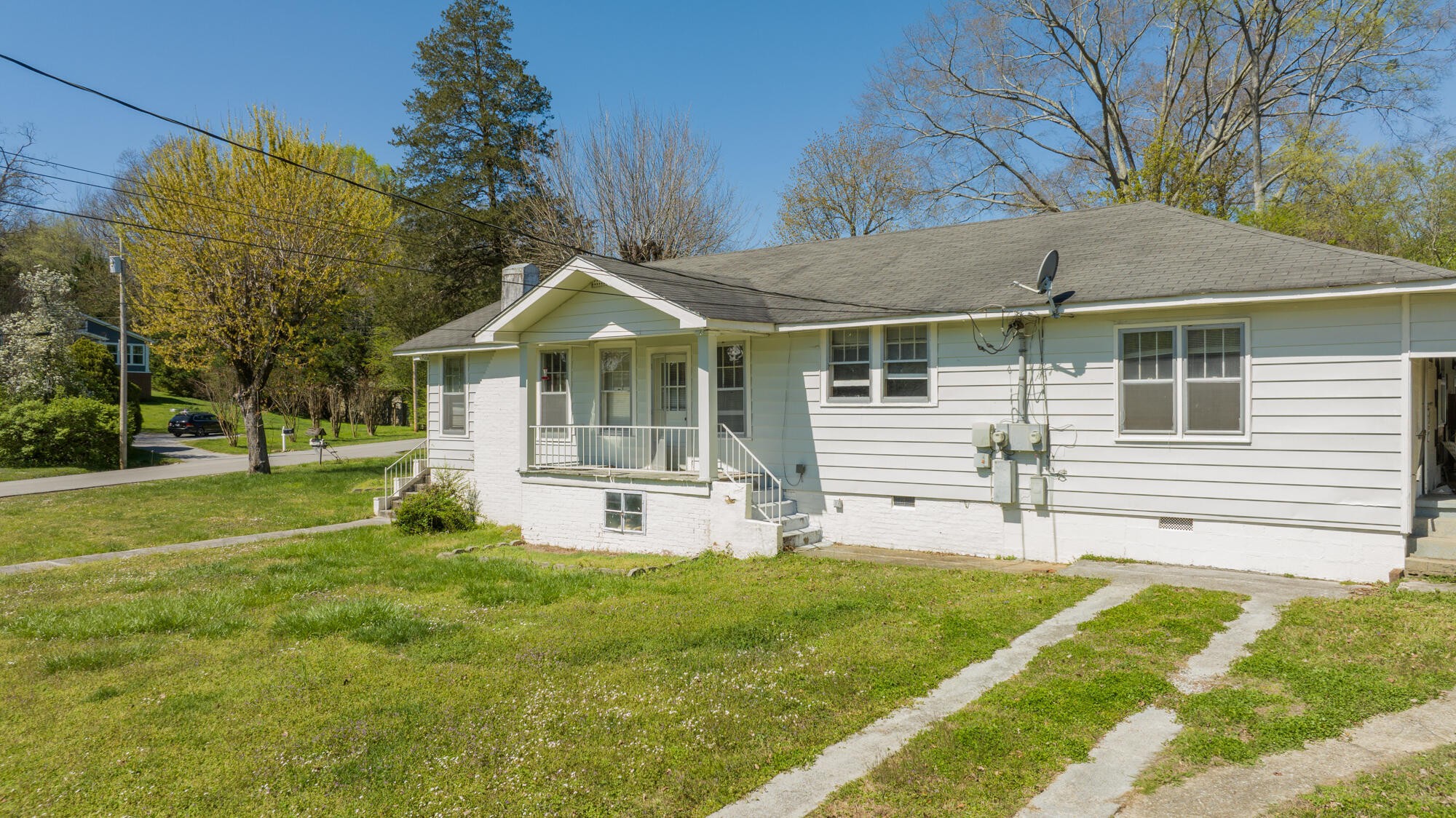 a front view of a house with a yard table and chairs