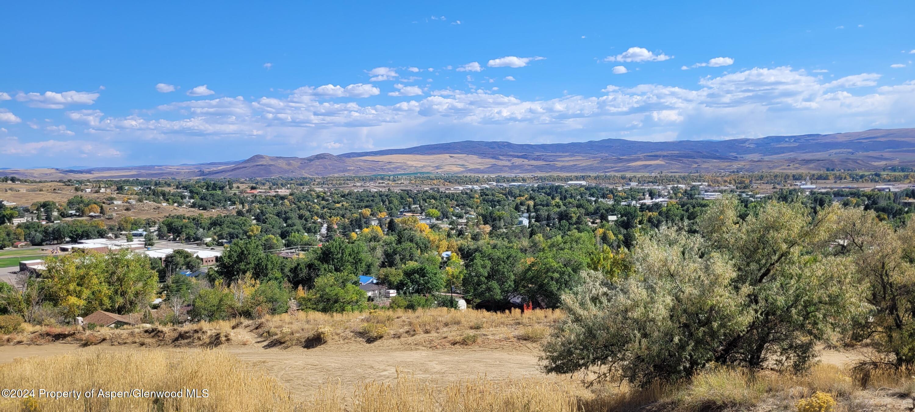 a view of a town with mountains in the background