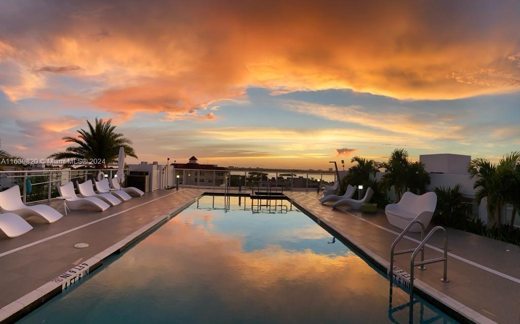 a view of a swimming pool with seating area