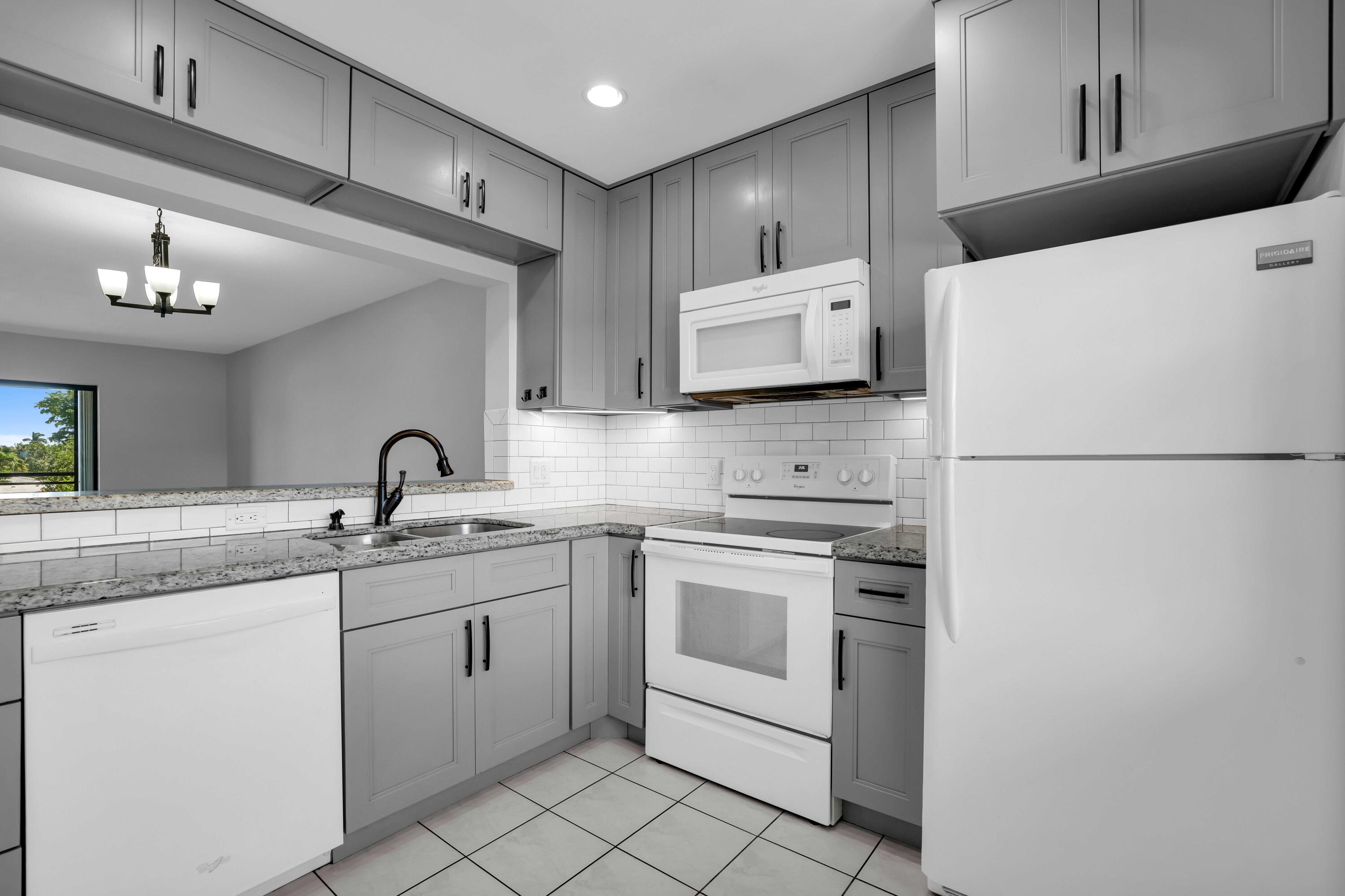 a kitchen with stainless steel appliances a sink and a refrigerator