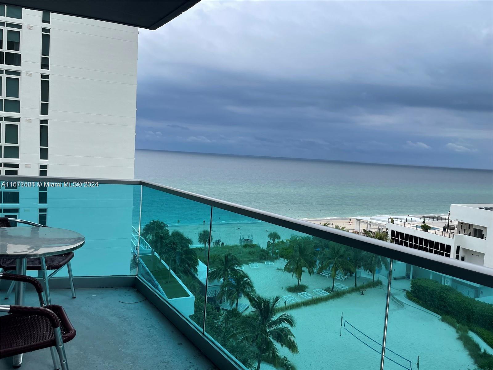 a balcony with a table and chairs