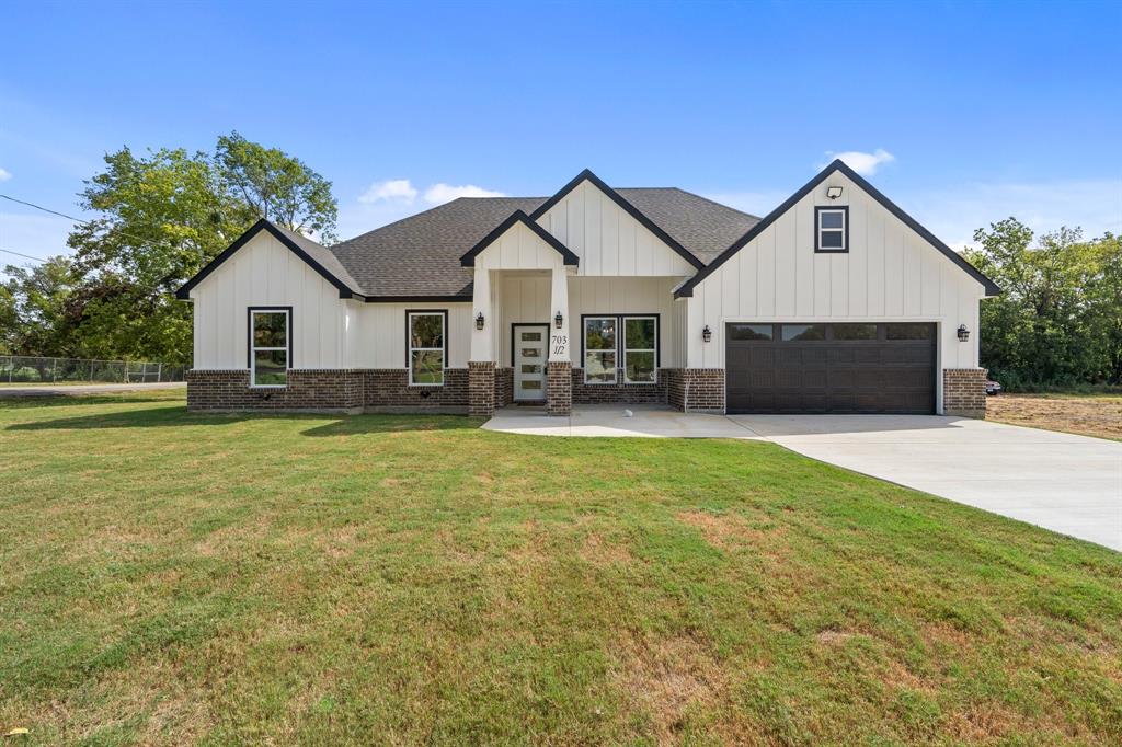 a front view of house with yard and green space