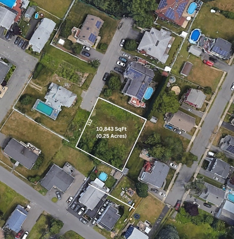 an aerial view of residential house with outdoor space and parking