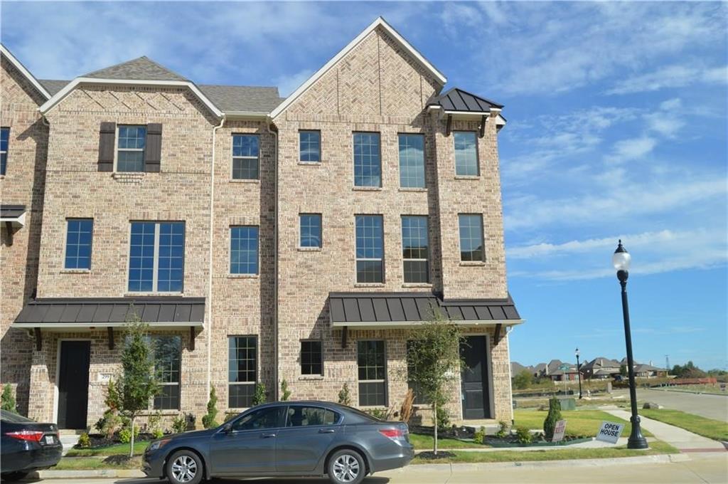 a front view of a residential apartment building with a yard