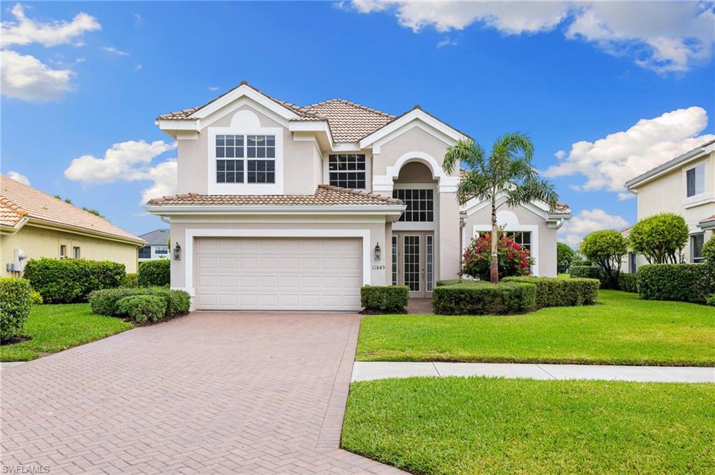 a front view of a house with a garden and yard