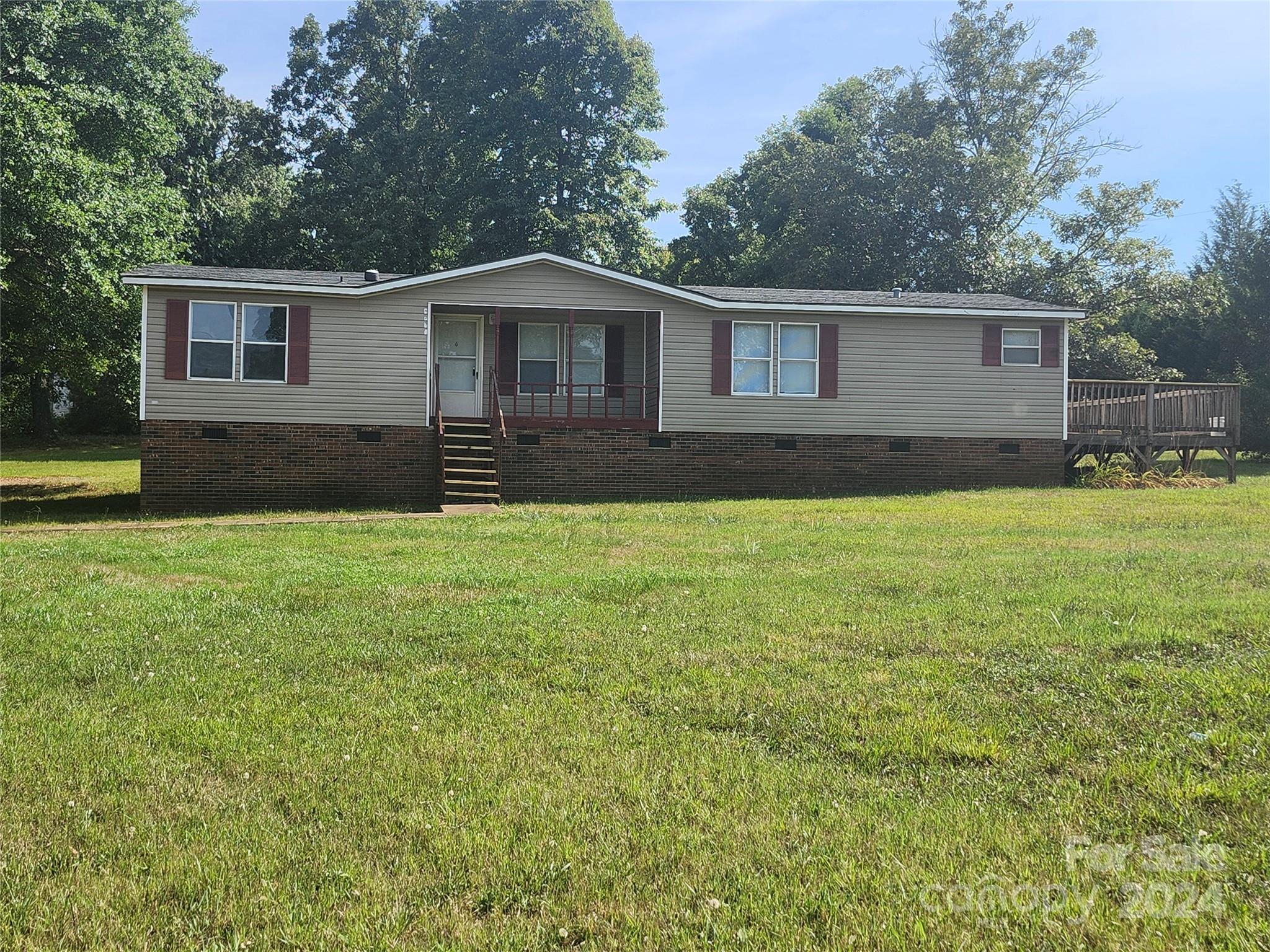 a front view of a house with yard and green space