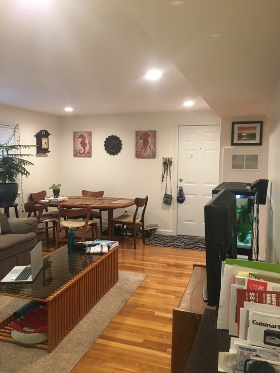 a kitchen with stainless steel appliances kitchen island granite countertop a table and chairs in it