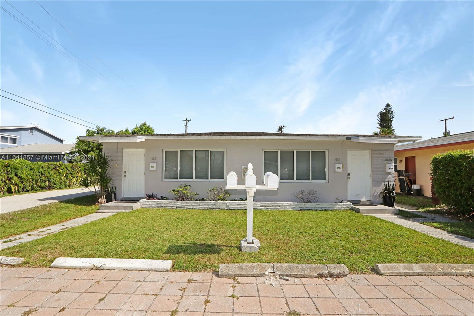 a front view of a house with a yard and porch