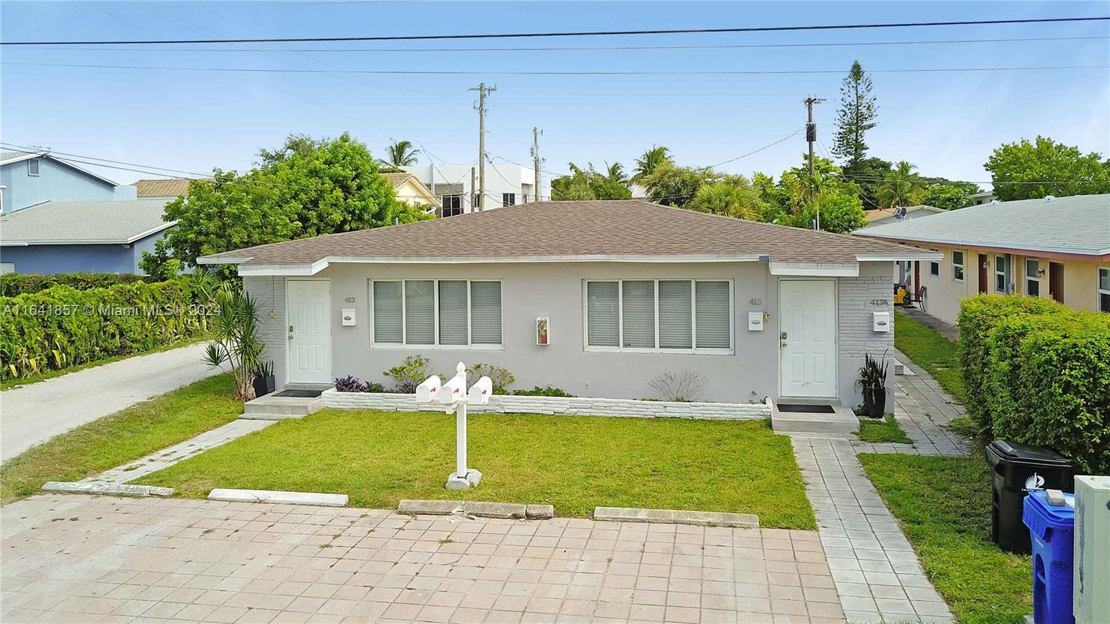 a view of a house with a yard patio and a small yard