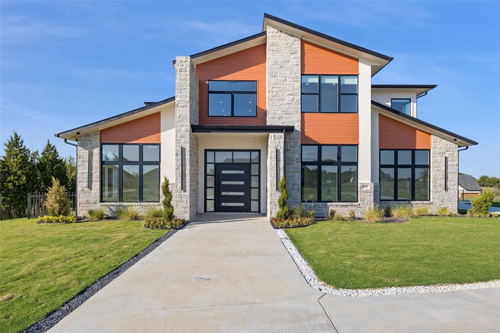 front view of a brick house with a yard