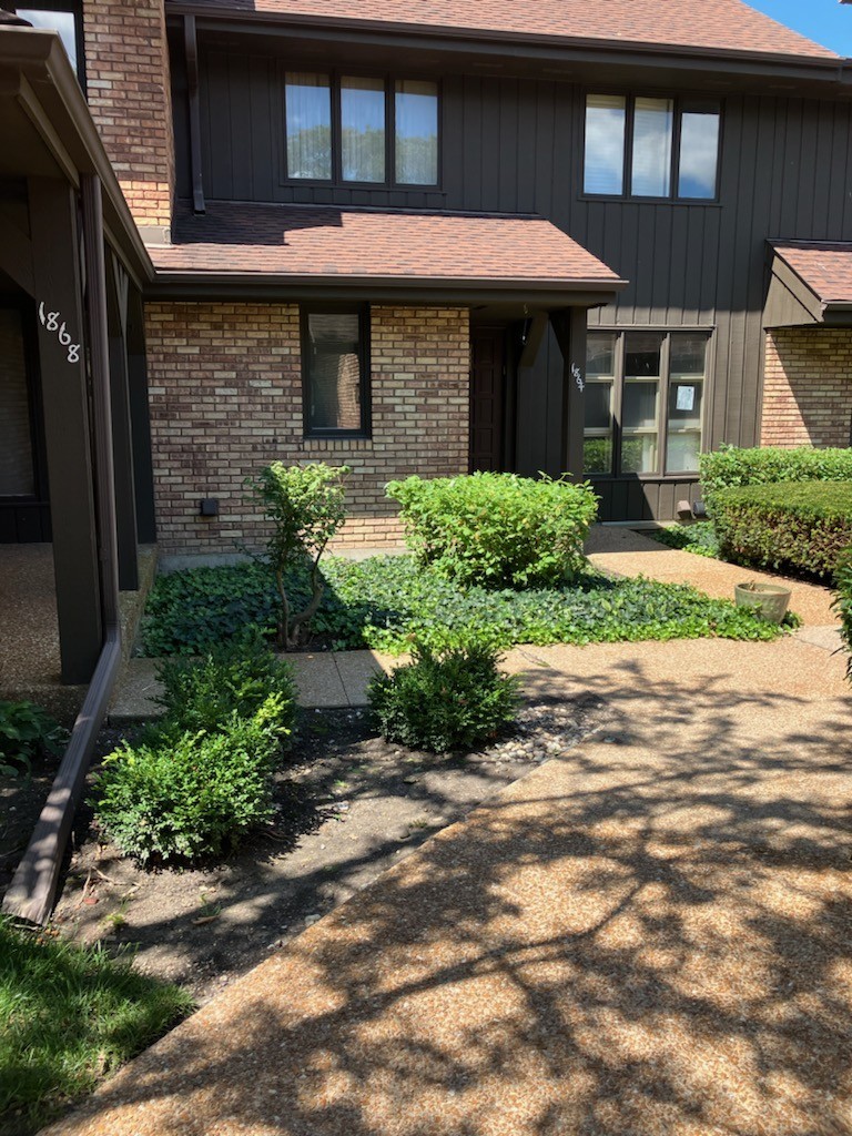 a front view of a house with garden