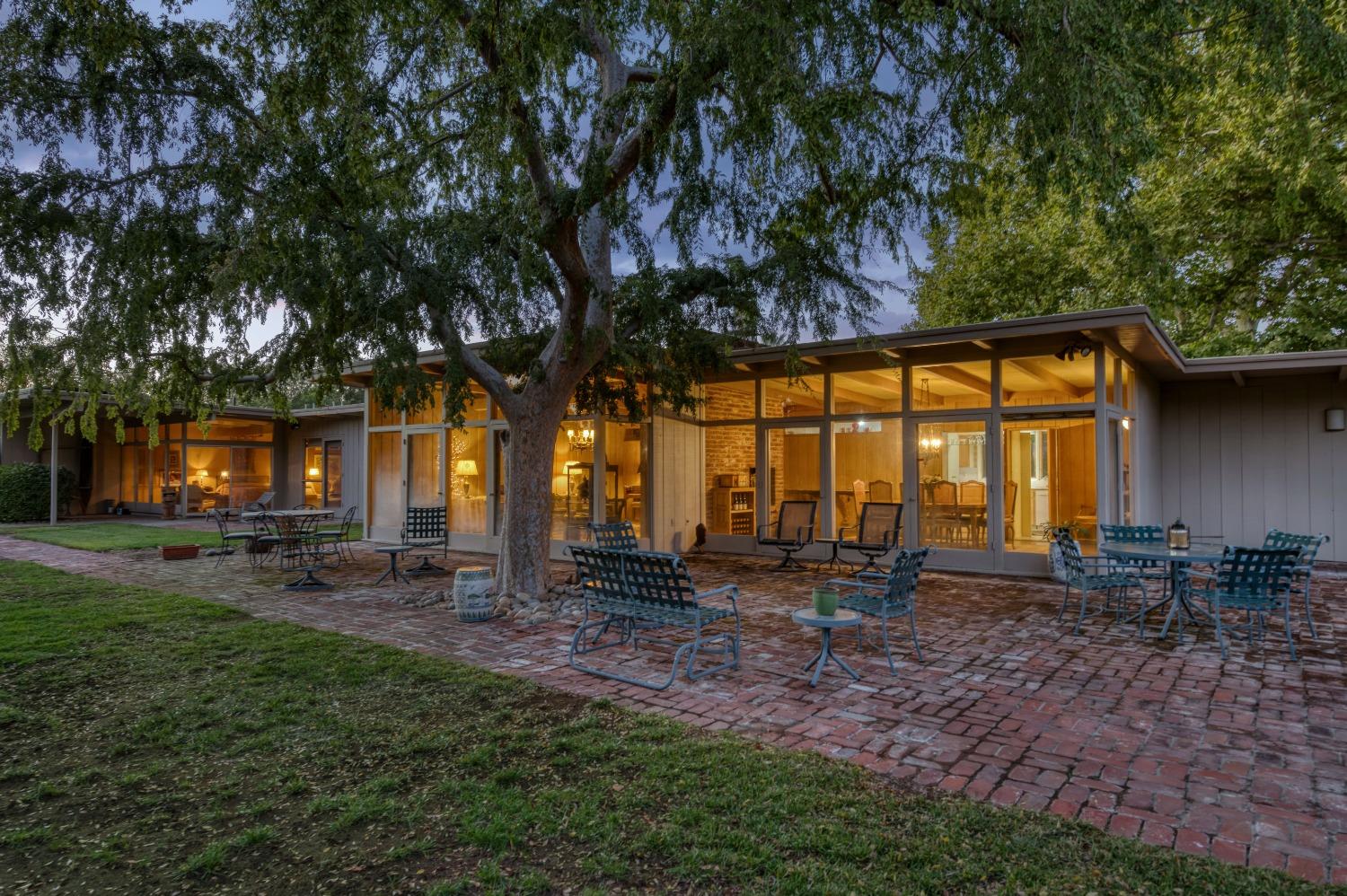 a view of a house with backyard and sitting area