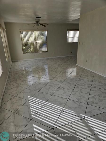 a view of a livingroom with a white wall and a dishwasher