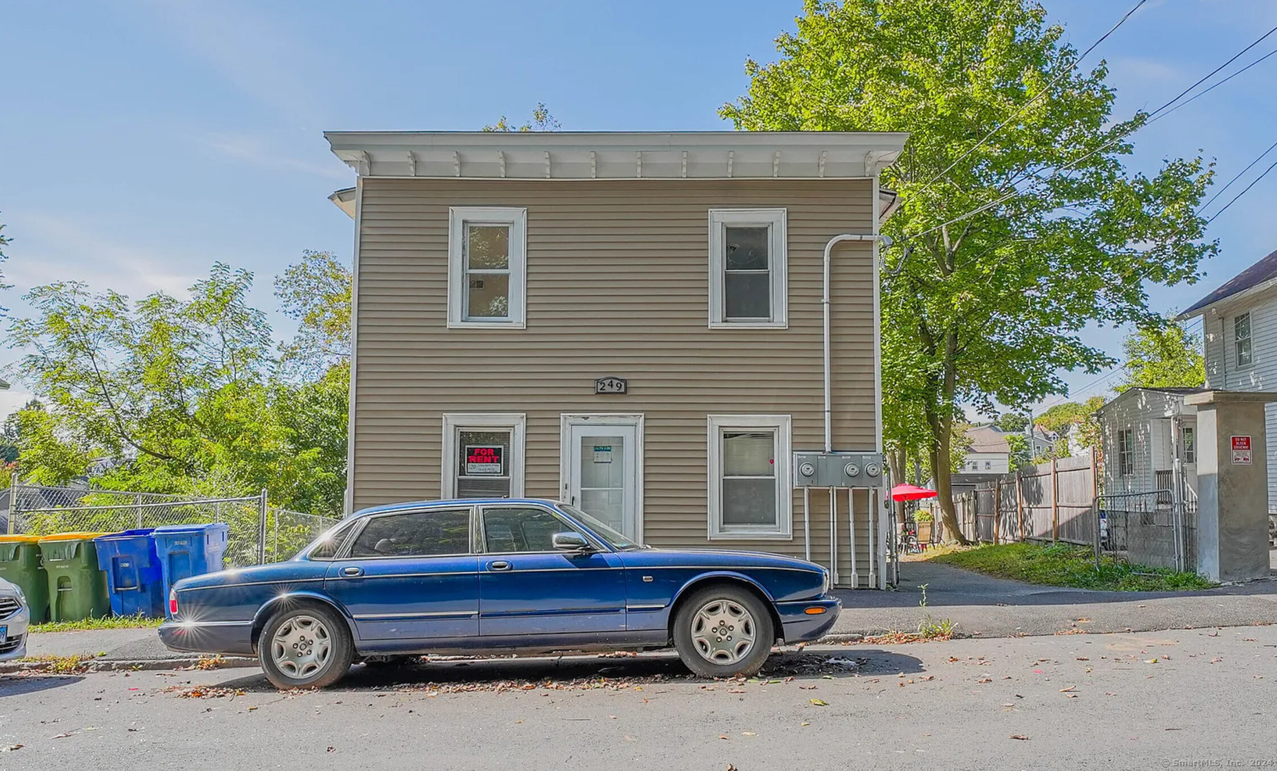 a front view of a house with parking space