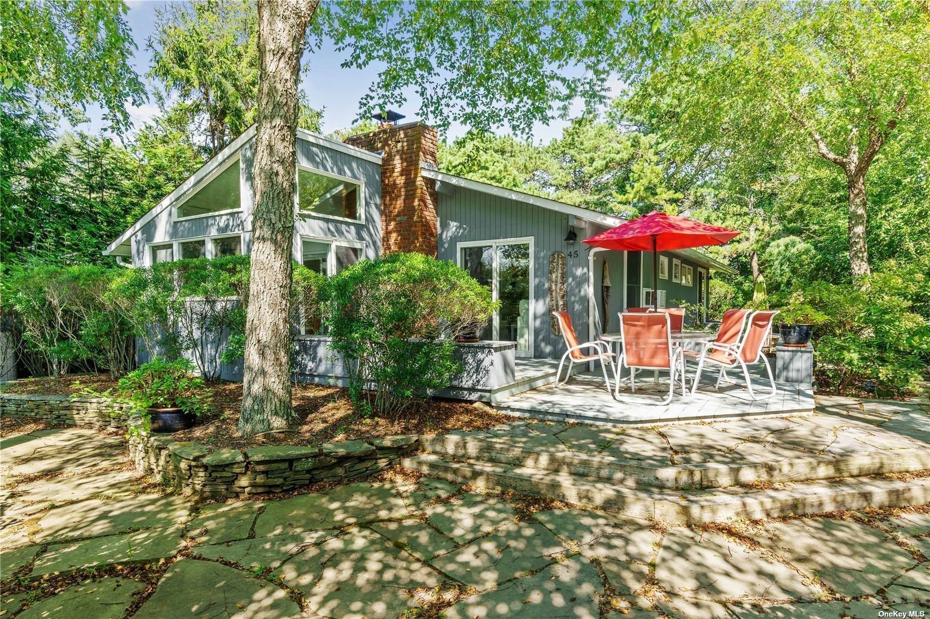 a view of a house with backyard and sitting area