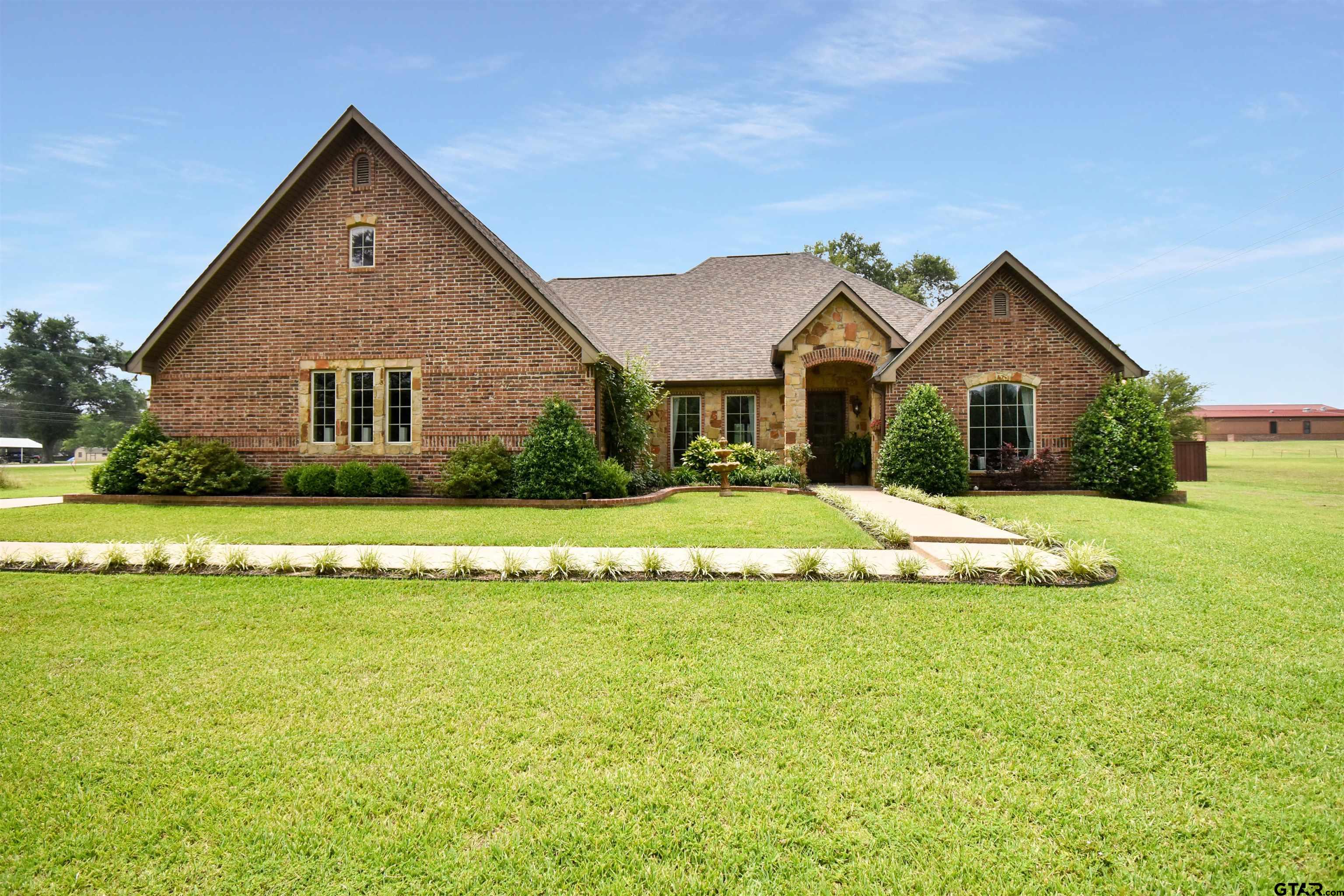 a front view of house with yard and green space