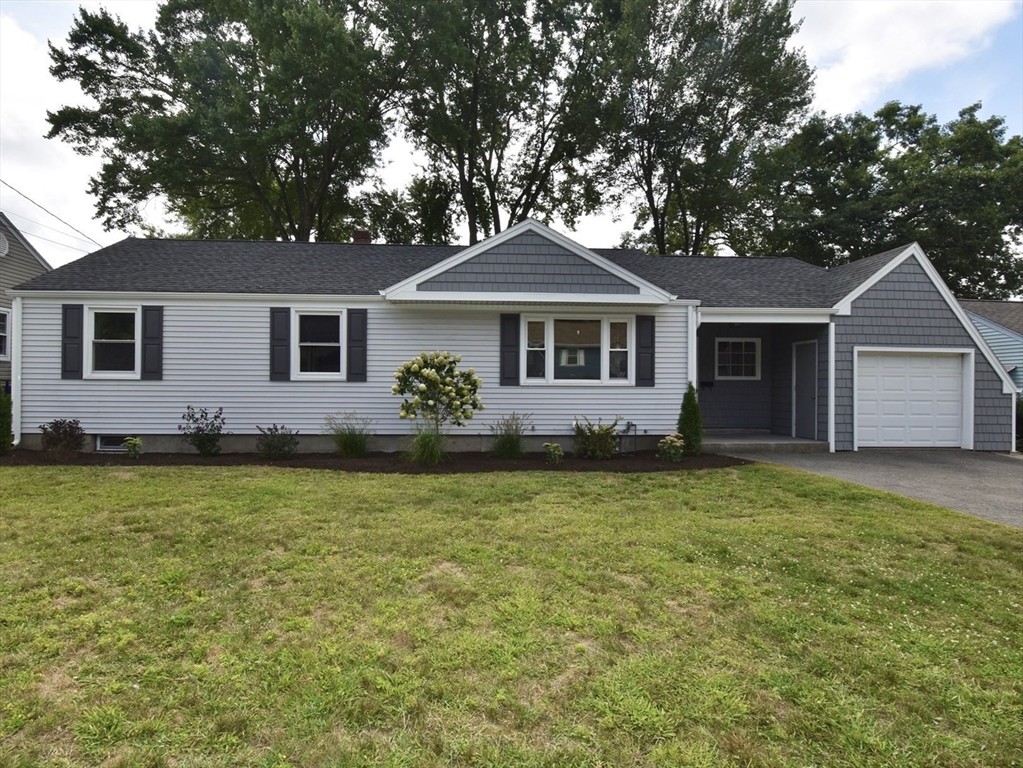 a front view of a house with garden