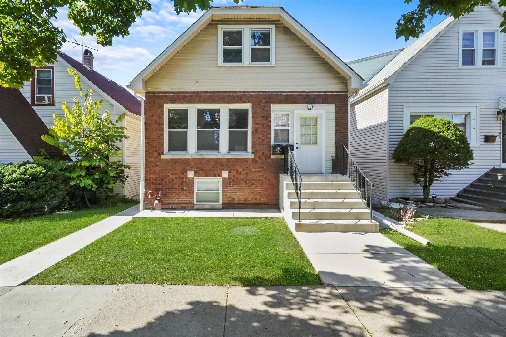 a front view of a house with a yard and porch