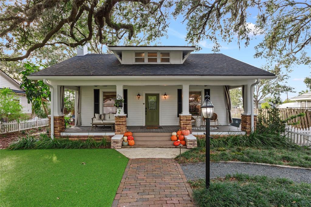 a front view of house with yard and outdoor seating