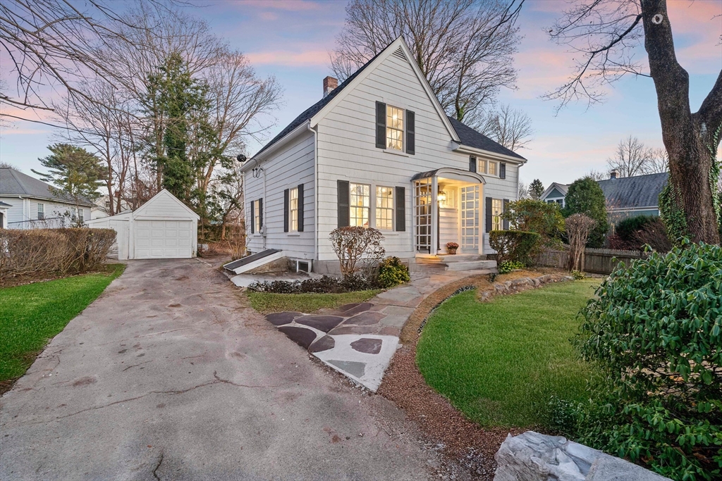 a front view of a house with garden and patio