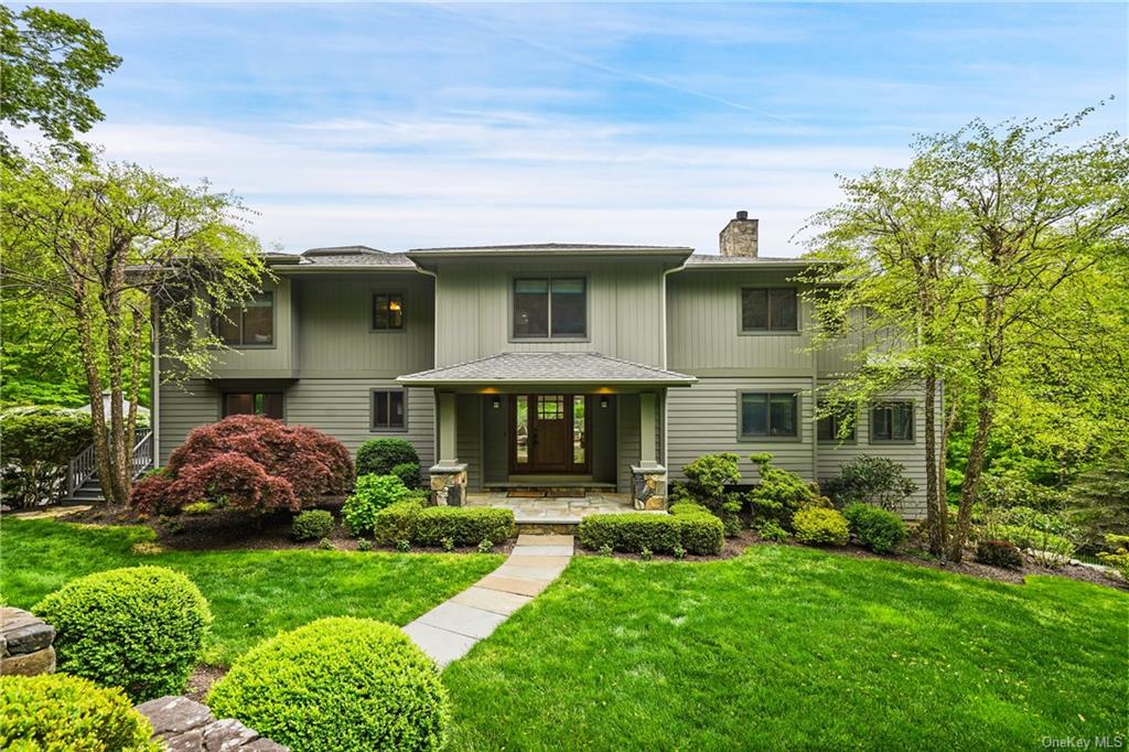 a front view of a house with a garden