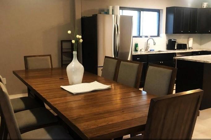 a dining room with furniture and wooden floor