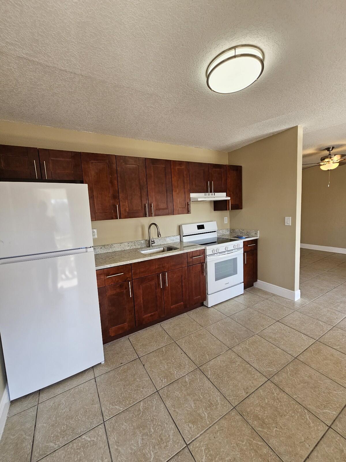 a kitchen with a cabinets and white appliances