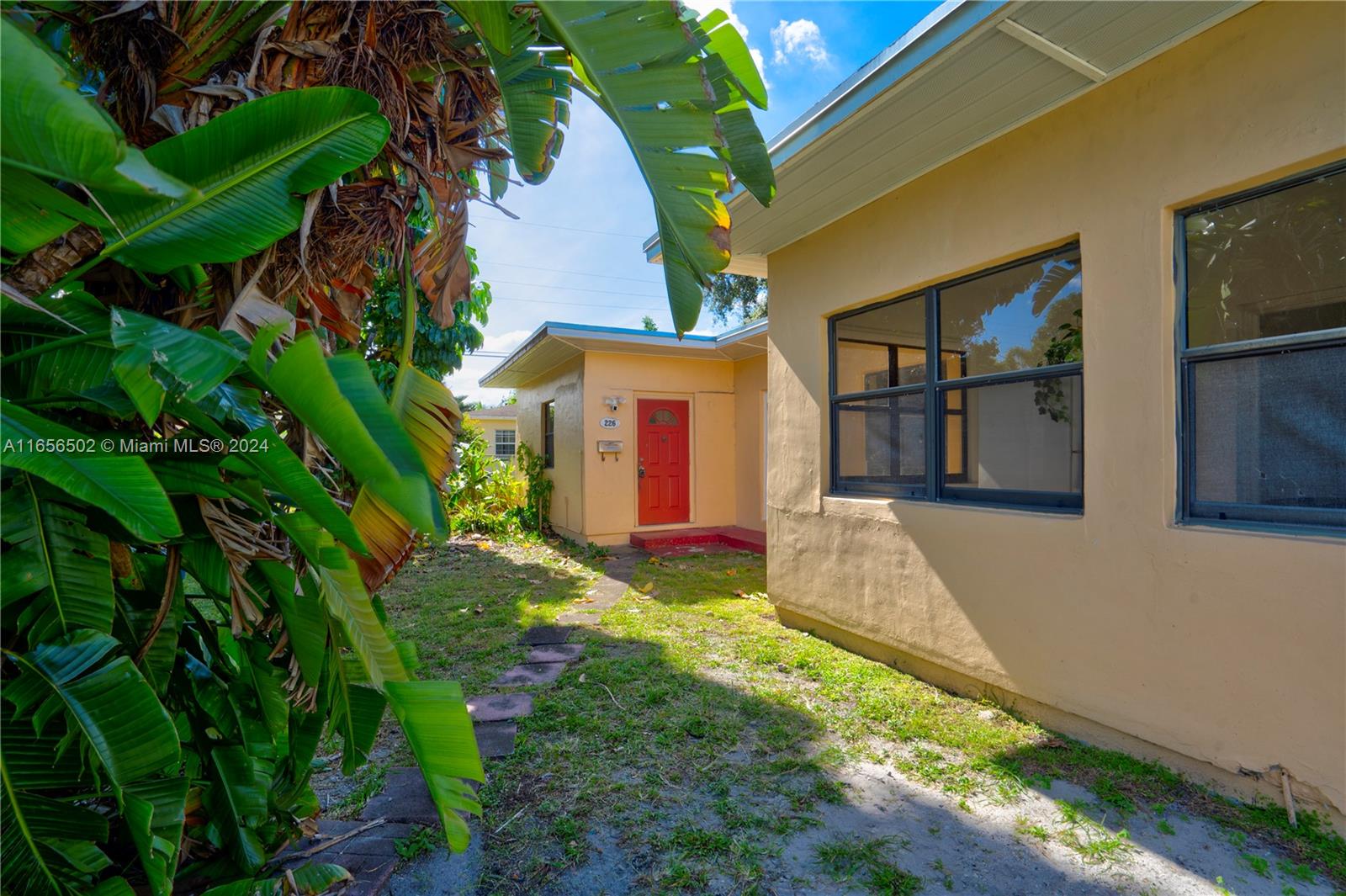 a view of a house with a yard and plants