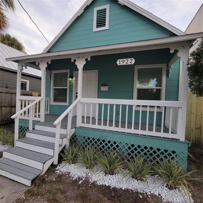 a view of a house with wooden fence