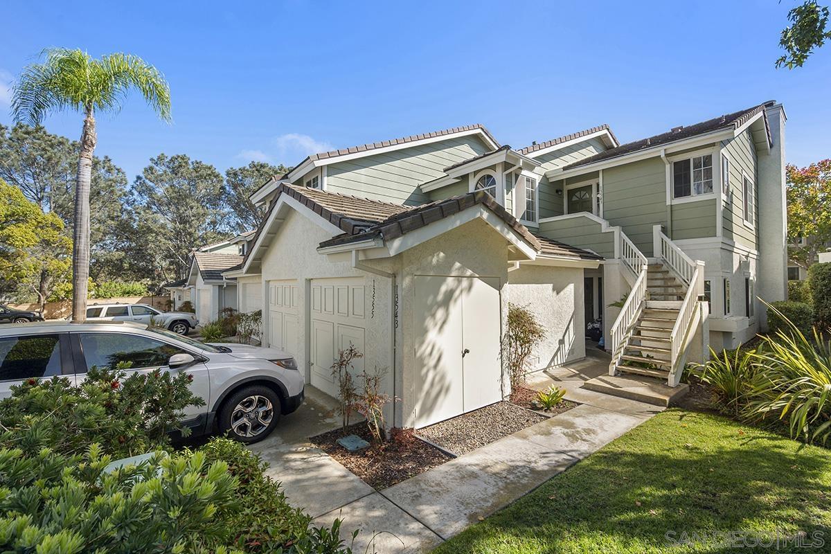 a view of a car garage next to a yard