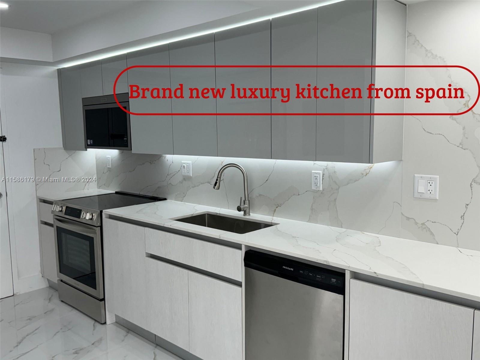 a view of a kitchen with stainless steel appliances granite countertop a sink and a stove