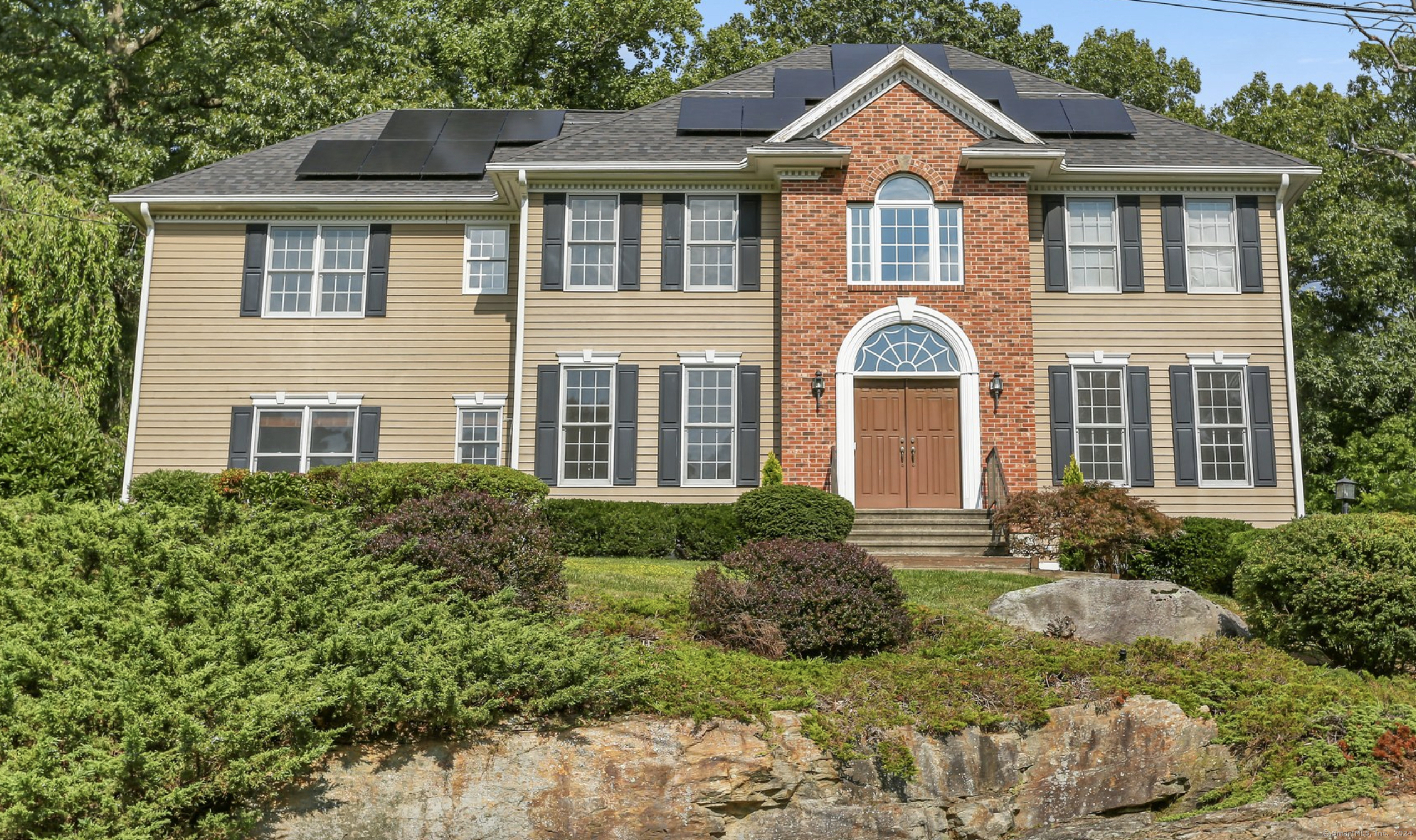 a front view of a house with garden