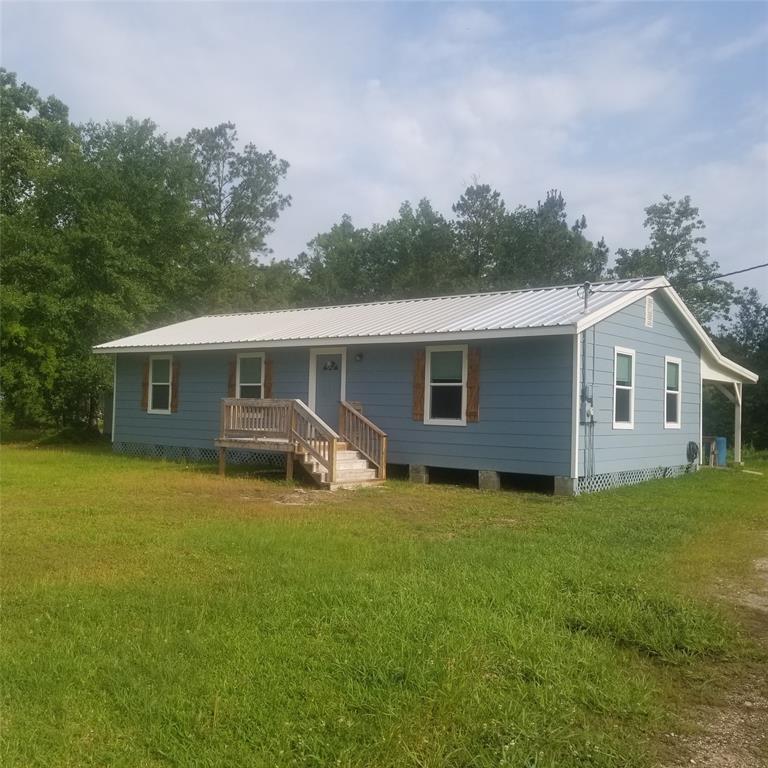 a view of a house with a yard and deck