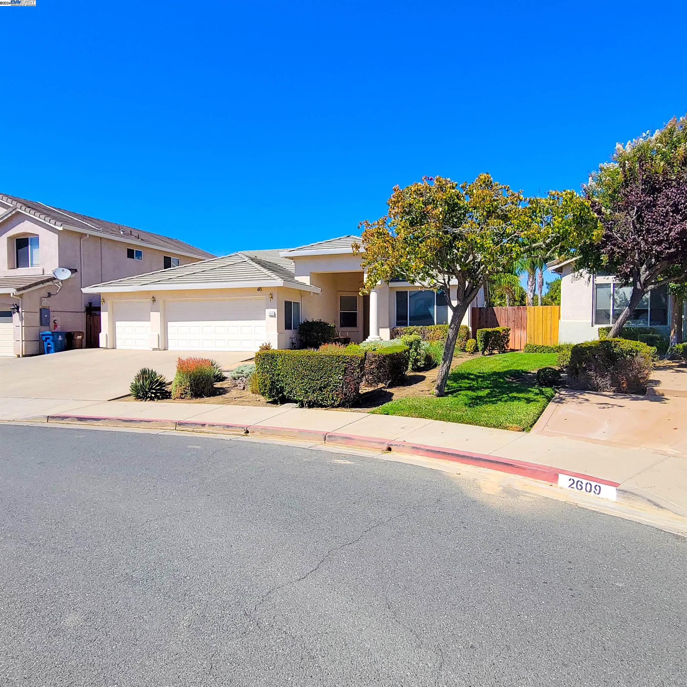 a front view of a house with a yard and a garage