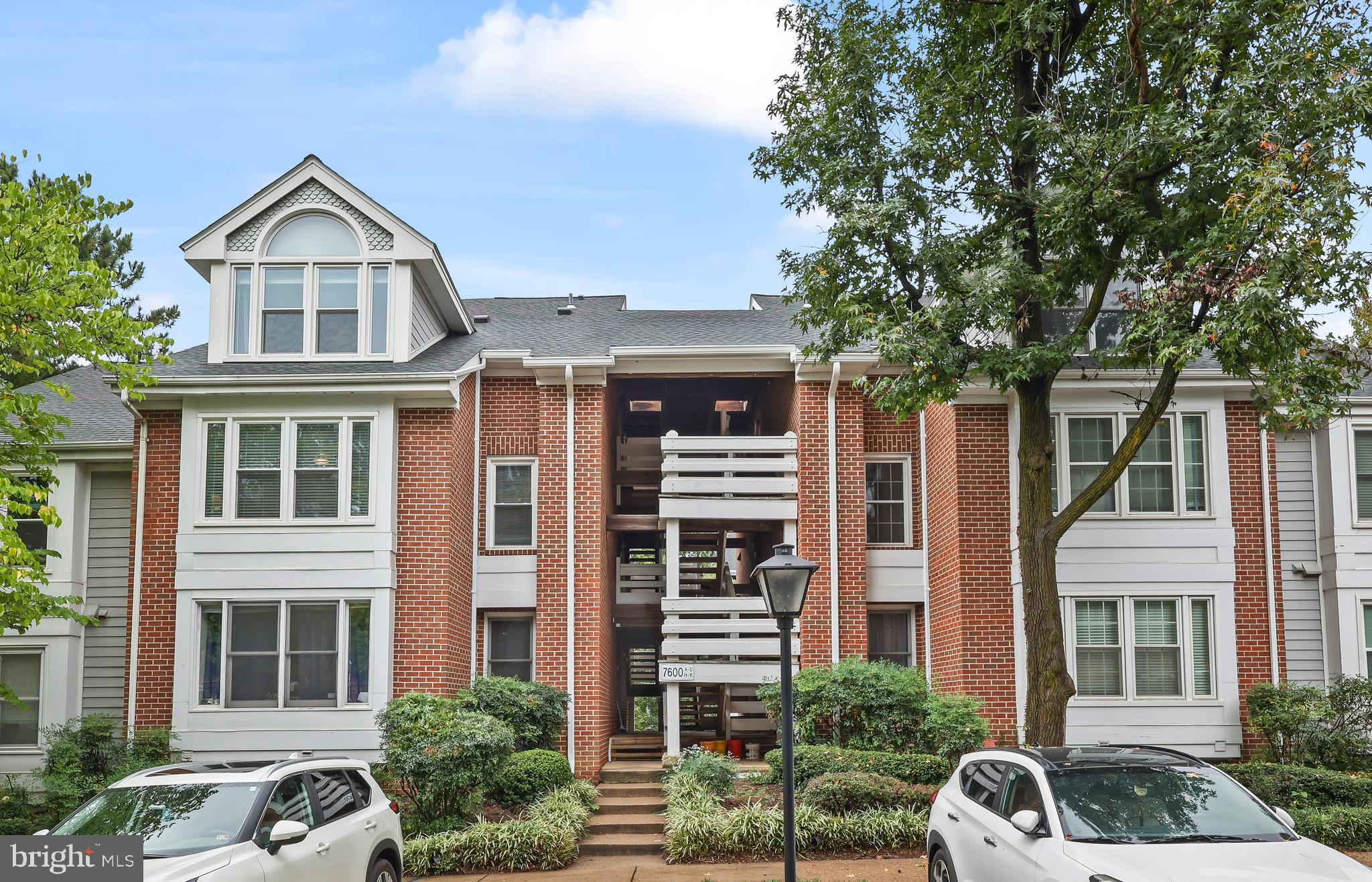 a front view of a residential apartment building with a yard