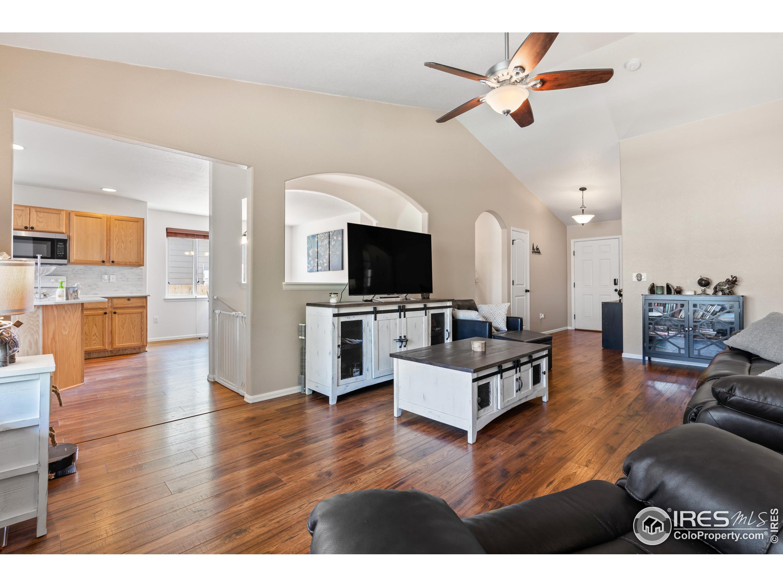 a living room with furniture wooden floor and a flat screen tv