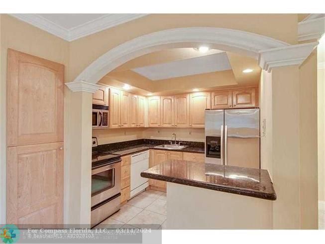 a kitchen with stainless steel appliances granite countertop a sink and cabinets