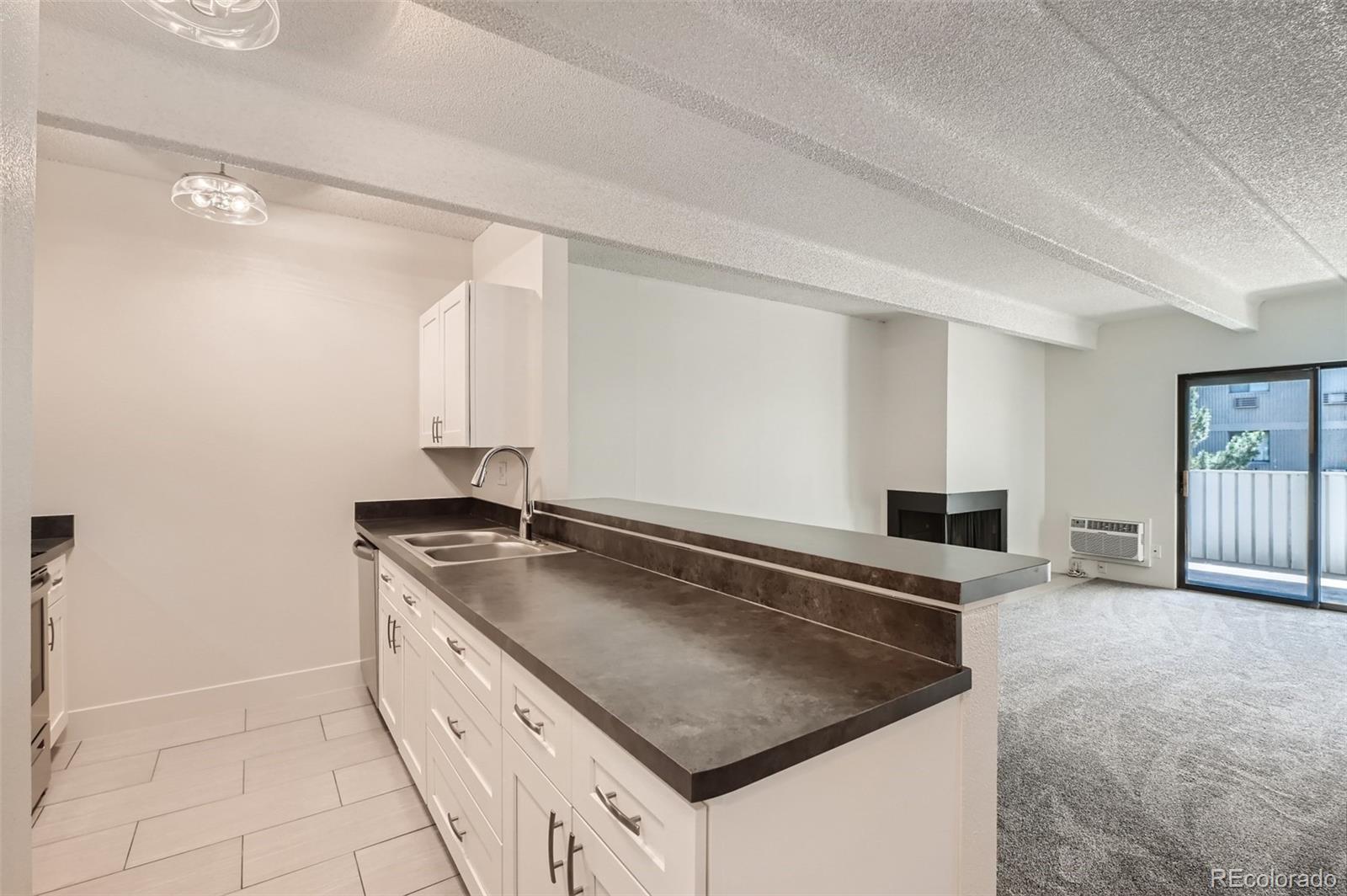 a kitchen with granite countertop a sink and a stove