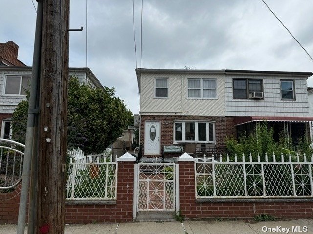 a front view of a house with plants