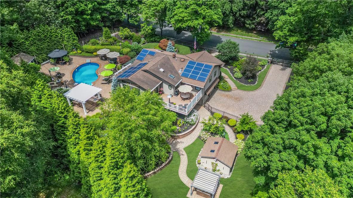 an aerial view of a house with a yard and lake view