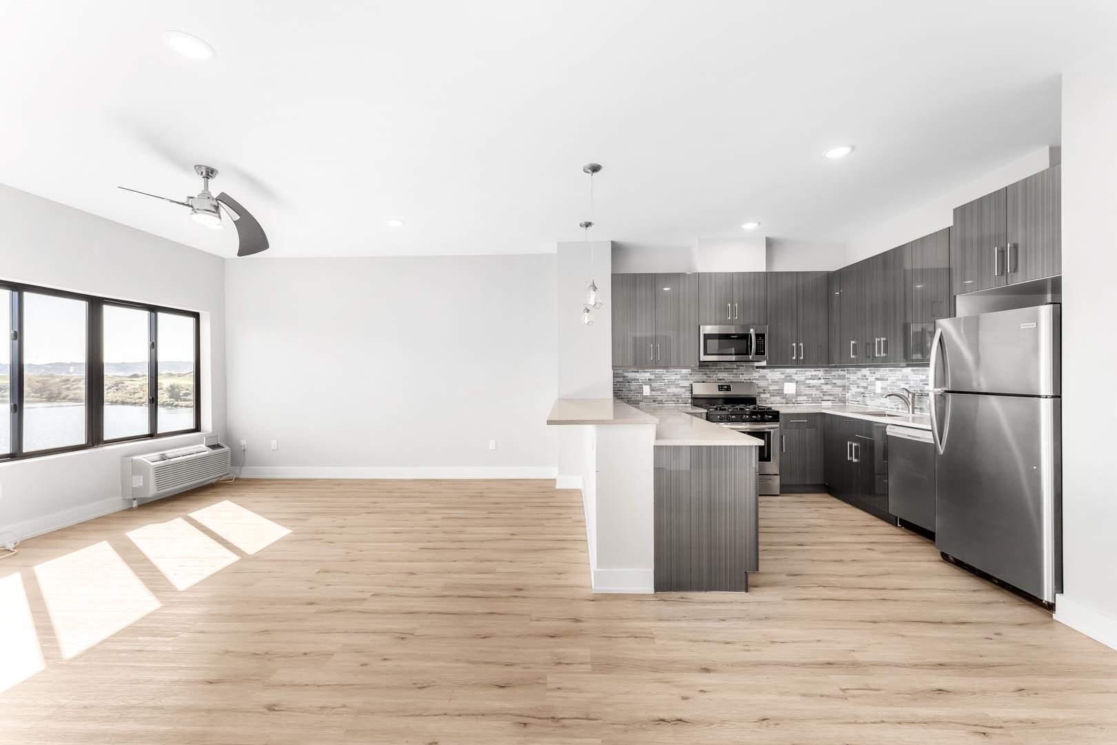 a kitchen with a refrigerator a sink and cabinets