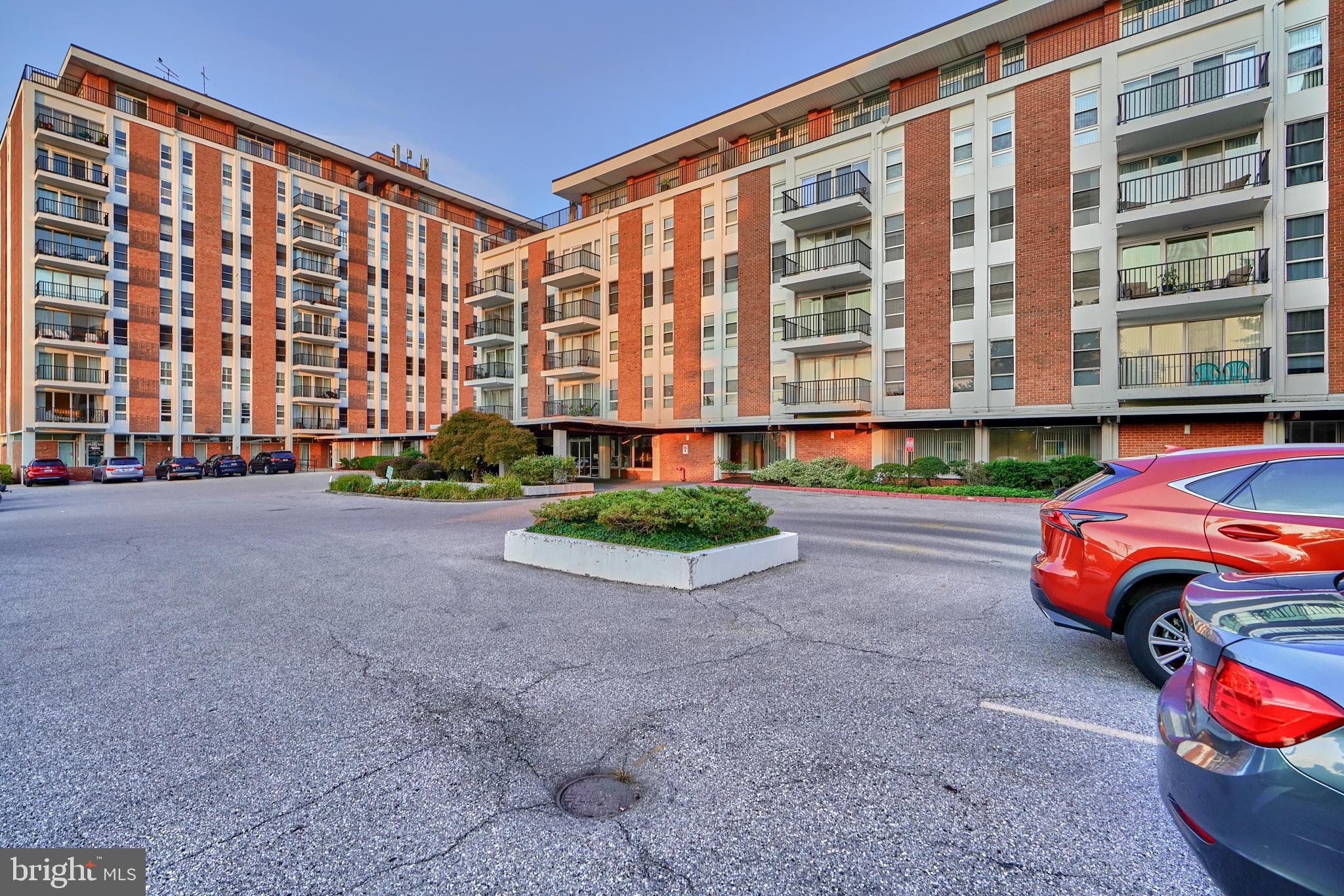 a front view of building with parking space and parking space