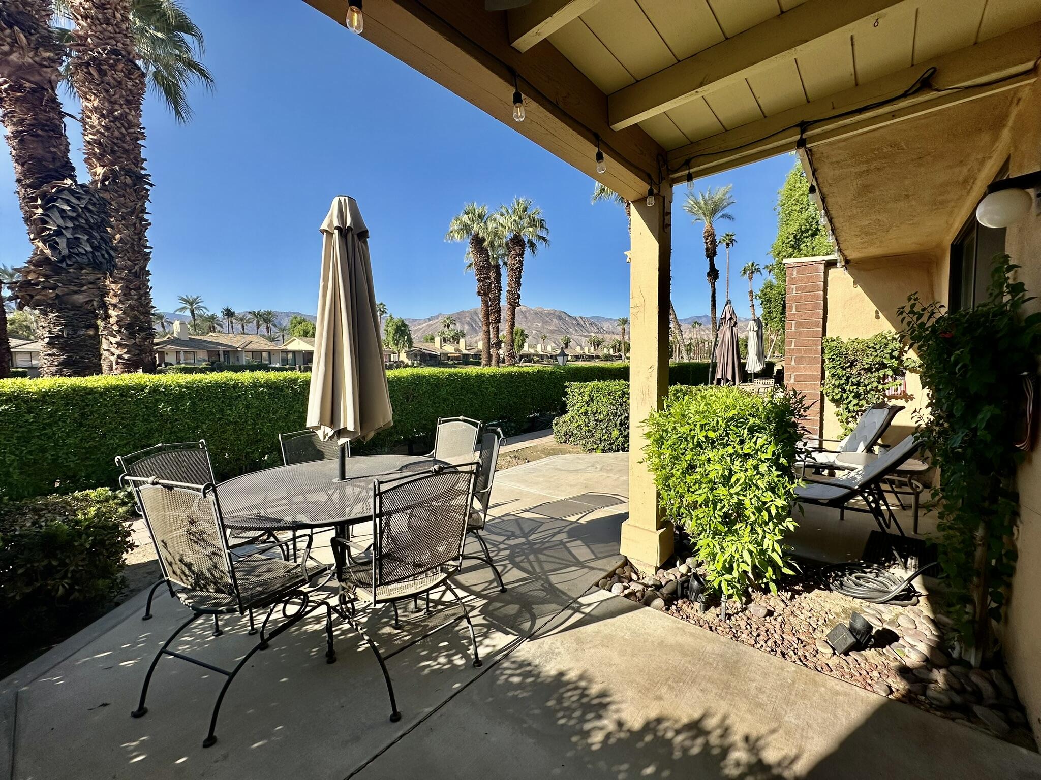 a view of an outdoor sitting area with furniture and garden