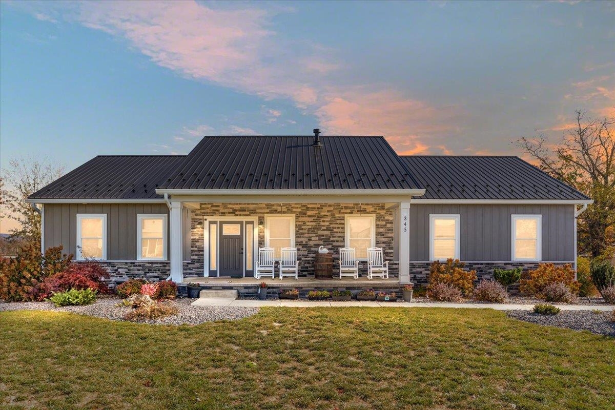 a front view of house with yard and outdoor seating